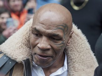Mike Tyson poses for selfies with fans in Italy as he steps out of his hotel in Turin with the boxing legend preparing to shoot a new movie
